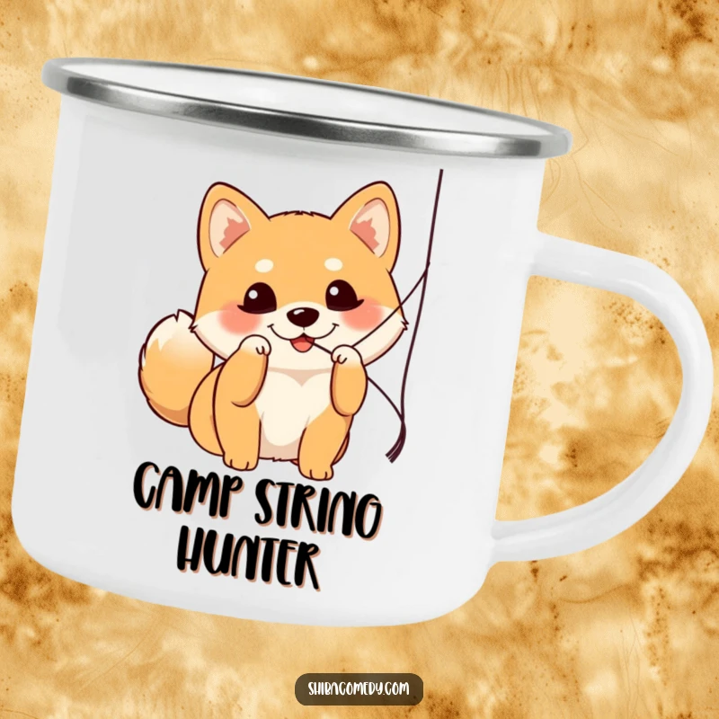 Funny Shiba Inu camping mug showing a dog with bright eyes batting a string, perfect for outdoor fun.