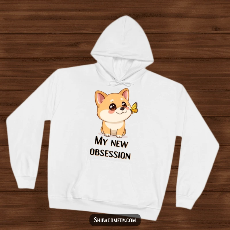 Funny Shiba Inu hoodie showing a dog with wide, curious eyes intently watching a butterfly flutter past, ideal for nature lovers.